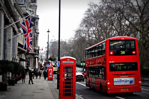 Typical London scene including a red double decker bus and phone box